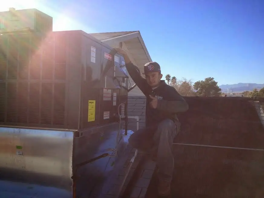 HVAC technician performing Heat Pump Repair on a rooftop unit in Easttown